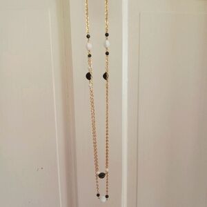 NEW. GOLD SETTING AND GOLD CHAIN WITH BLAK AND WHITE BEADS.  CHAIN CAN BE DOUBLE